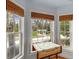 Cozy breakfast nook with bright windows offering serene views of the landscaped surroundings at 4871 Hoyer Dr, Sarasota, FL 34241