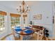 Dining area with round table by bay windows with bamboo shades and decor at 4871 Hoyer Dr, Sarasota, FL 34241