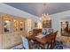 Elegant dining room features a chandelier, china cabinet and blue accent decor at 4871 Hoyer Dr, Sarasota, FL 34241