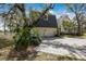 View of the house exterior including a two-car garage and mature landscaping at 4871 Hoyer Dr, Sarasota, FL 34241