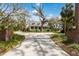 Inviting two-story home featuring a classic porch with rocking chairs and mature trees at 4871 Hoyer Dr, Sarasota, FL 34241