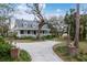 Charming yellow two-story home featuring a welcoming front porch and a long driveway at 4871 Hoyer Dr, Sarasota, FL 34241