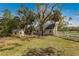 Charming home with a well-maintained yard and a quaint outbuilding, offering serene countryside living at 4871 Hoyer Dr, Sarasota, FL 34241