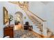 Elegant foyer with staircase, chandelier, and hardwood floors, creating a grand entrance at 4871 Hoyer Dr, Sarasota, FL 34241