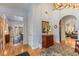 Bright foyer featuring hardwood floors, arched doorways, and elegant furnishings at 4871 Hoyer Dr, Sarasota, FL 34241