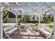 Inviting pergola sitting area with brick pavers and a lovely view of the house at 4871 Hoyer Dr, Sarasota, FL 34241