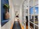 Hallway leading to a home office and bedroom, featuring hardwood floors and decorative touches at 4871 Hoyer Dr, Sarasota, FL 34241