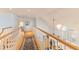 Upstairs hallway with hardwood floors, white railings, and natural light from the staircase window at 4871 Hoyer Dr, Sarasota, FL 34241