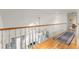 Upstairs hallway with hardwood floors, white railings, and elegant chandelier at 4871 Hoyer Dr, Sarasota, FL 34241