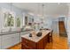 Bright kitchen with an island, bar seating, and direct views into the breakfast nook and stairway at 4871 Hoyer Dr, Sarasota, FL 34241
