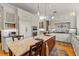 Traditional kitchen features granite countertops, a central island with seating, and custom white cabinetry at 4871 Hoyer Dr, Sarasota, FL 34241
