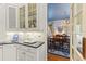 Kitchen space that opens into a dining area with hardwood floors and elegant blue decor at 4871 Hoyer Dr, Sarasota, FL 34241