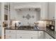 Detailed view of a kitchen stove and backsplash with custom tilework, complemented by granite countertops at 4871 Hoyer Dr, Sarasota, FL 34241