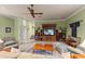 Spacious living room featuring plush seating, a ceiling fan, and built-in media center at 4871 Hoyer Dr, Sarasota, FL 34241