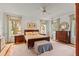 Bright and spacious main bedroom with hardwood floors, large windows, and neutral decor at 4871 Hoyer Dr, Sarasota, FL 34241