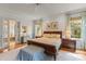 Bedroom with hardwood flooring and ample natural light, connecting to a visible bath space at 4871 Hoyer Dr, Sarasota, FL 34241