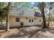 Quaint outbuilding featuring white trim and surrounded by mature trees, perfect for storage or workshop at 4871 Hoyer Dr, Sarasota, FL 34241