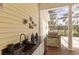 Outdoor kitchen with a built-in grill, sink, and granite countertop on the brick patio at 4871 Hoyer Dr, Sarasota, FL 34241