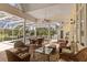 Spacious screened-in patio with comfortable seating and views of the sparkling pool at 4871 Hoyer Dr, Sarasota, FL 34241