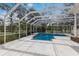 Inviting screened-in pool area surrounded by lush greenery and a white fence at 4871 Hoyer Dr, Sarasota, FL 34241
