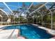 Backyard swimming pool offering cool, blue water and relaxing sunshine under a white enclosure at 4871 Hoyer Dr, Sarasota, FL 34241