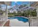 Relax in this screened-in pool with brick accents, offering a private and serene outdoor experience at 4871 Hoyer Dr, Sarasota, FL 34241