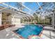 Enclosed swimming pool offering clear blue waters and relaxing sunshine under a white enclosure at 4871 Hoyer Dr, Sarasota, FL 34241
