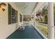 Relaxing porch with rocking chairs and ceiling fans, perfect for enjoying the outdoors at 4871 Hoyer Dr, Sarasota, FL 34241