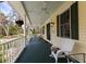 Spacious porch with classic white railings, offering ample seating and outdoor ambiance at 4871 Hoyer Dr, Sarasota, FL 34241
