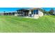 Expansive backyard with patio seating ideal for entertaining, adjacent to neighboring properties at 5015 98Th E Ave, Parrish, FL 34219