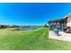 Spacious backyard featuring a patio with seating, offering a peaceful view of the pond at 5015 98Th E Ave, Parrish, FL 34219