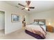 Cozy bedroom featuring a ceiling fan, ensuite bathroom, and soothing decor at 5015 98Th E Ave, Parrish, FL 34219