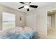 Bright bedroom with a ceiling fan, window, closet, seahorse decor, and a beach-themed comforter at 5015 98Th E Ave, Parrish, FL 34219