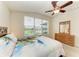 Light-filled bedroom with a large window offering a peaceful view and a ceiling fan at 5015 98Th E Ave, Parrish, FL 34219