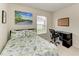 Comfortable bedroom featuring a work desk, bright window, and modern decor at 5015 98Th E Ave, Parrish, FL 34219