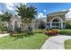 Beautiful exterior elevation with stone accents, lush landscaping, and a welcoming walkway at 5015 98Th E Ave, Parrish, FL 34219