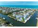 An aerial view of the home and property with lush landscaping at 511 Loquat Dr, Anna Maria, FL 34216