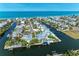 An aerial view of waterfront homes with boat docks and pools along canals in a coastal community at 511 Loquat Dr, Anna Maria, FL 34216