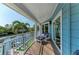 Waterfront balcony with cozy seating area providing a tranquil outdoor retreat at 511 Loquat Dr, Anna Maria, FL 34216