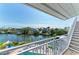 Balcony view of canal and pool area surrounded by palm trees at 511 Loquat Dr, Anna Maria, FL 34216