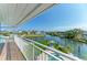 Balcony view overlooks a canal and pool and lush landscaping at 511 Loquat Dr, Anna Maria, FL 34216