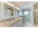 Elegant bathroom featuring dual sinks with granite countertops and marble floors at 511 Loquat Dr, Anna Maria, FL 34216