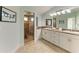 Elegant bathroom with double vanity, granite countertops, and a glass-enclosed shower at 511 Loquat Dr, Anna Maria, FL 34216