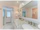 Elegantly designed bathroom with dual sinks, marble countertops, and a glass shower at 511 Loquat Dr, Anna Maria, FL 34216
