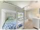 Bedroom features built-in bunk beds, blue bedding, wood floors and ample natural light at 511 Loquat Dr, Anna Maria, FL 34216