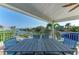 Covered patio features a large dining table for entertaining with views of the waterway at 511 Loquat Dr, Anna Maria, FL 34216