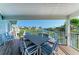 Inviting covered patio with views of the canal and comfortable seating for outdoor dining at 511 Loquat Dr, Anna Maria, FL 34216