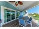 Covered patio with dining area and sliding doors leading inside the home at 511 Loquat Dr, Anna Maria, FL 34216