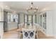 Dining room featuring tray ceilings, picture windows, and seating for ten at 511 Loquat Dr, Anna Maria, FL 34216