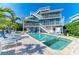 Stunning multi-story home features a private pool, multiple balconies, and outdoor entertaining spaces at 511 Loquat Dr, Anna Maria, FL 34216